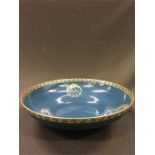 A Royal Worcester 1920's blue sponged and gilt highlights glazed bowl.