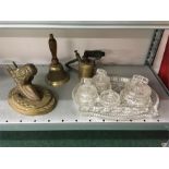 A brass horse head, brass school bell, blowtorch and dressing table set.