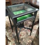 A small stained as mahogany Victorian glass top Bijouterie table resting on square legs