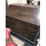 A large Georgian mahogany drop flap bureau. fitted draws rest on bracket feet