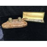 A pair of boxed French silver handled salad servers and a marble desk top stand with two brass