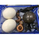 Two ostrich eggs with wooden carvings.