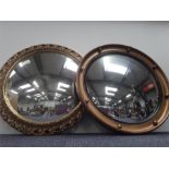 Two round wall hanging mirrors.