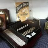 An Autoharp by E. H. Wickham together with booklet First Step how to play the Autoharp.