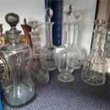 Six glass decanters together with four champagne flutes.