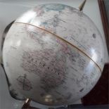 A globe on brass stand wooden base.