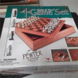 A boxed Pewter and Wood four game set: Draughts, Backgammon, Tic tac Toe and chess.