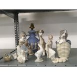 Eight Lladro figures together with a Wedgwood lamp base.