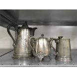 Three silver plated items. A large Victorian Britannia metal beer jug together with a teapot and a