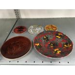 A collection of Poole Pottery plates to include a charger.