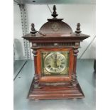 A wooden cased mantle clock.