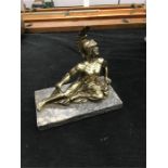 A bronzed figure on marble base.