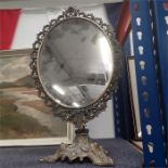 An ornate brass framed vanity mirror.