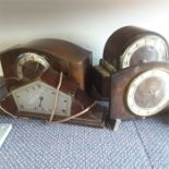 Four wooden mantle clocks.