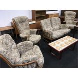 A four piece mid 20th century Ercol living room suite comprising two seater sofa and three chairs.