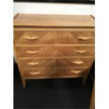 A 1970's style light oak chest of four drawers.