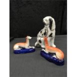 Three Staffordshire dogs: a pair of greyhound pen holders and a flat back spaniel.(some damage).