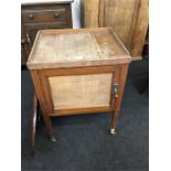 A mahogany and oak pot cupboard.