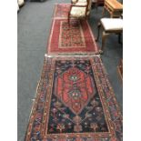 Three vintage patterned carpets.