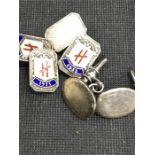 A pair of silver and enamel cuff links bearing the initial “H. 1953” and one other pair.