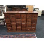 A mahogany chest of 24 small drawers.