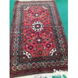 An all over floral border persian design carpet decorated in colours of blue cream and red