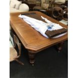 A large oak Victorian extending table with two extra leaves.