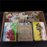 A quantity of cigarette and collectable cards together with various stamp albums.