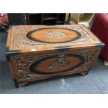 A wooden carved coffer box.