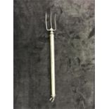 A silver telescopic toasting fork. af