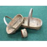 Two Sussex trugs and a pair of hand operated bellows.