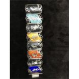 A hinged silver Thailand bracelet with enamelled panels in various colours.