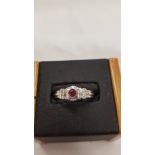 A 9 carat gold ruby and diamond white gold ring.