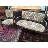 An Edwardian suite comprising of a two seater sofa and armchair.