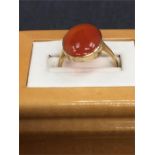 A gold ring ring set with agate stone.