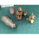 A collection of garden animal ornaments including a rabbit, badger and hedgehog.