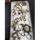 A box of gold and silver jewellery including rings and chains.