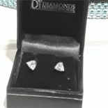 A pair of Swarovski earrings set in 9ct white gold, an emerald and silver ring and matching