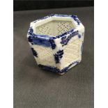 A six sided blue and white pot in the Chinese style (4” high).