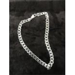 A heavy silver chain necklace.