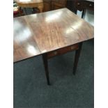 An antique mahogany drop flap Pembroke design table.