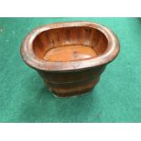 A Chinese wooden baby bath on bucket shaped stand.