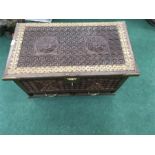 A hardwood carved trunk with brass fittings. and interior candle box.