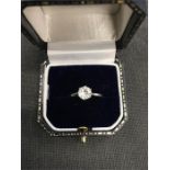 A 9ct white gold ring set with a single moissanite.