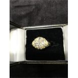 A diamond cluster ring of old cut diamonds of approx. 1 carat in total set in 18ct. Gold.