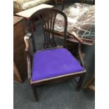 A mahogany chair with purple seat pad.