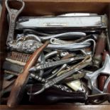 A box of various metal collectables, bottle openers, harmonica, corkscrews, enamel car badge, etc.