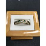 An emerald and diamond half hoop eternity ring set in 18ct gold. Size T.