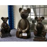 Three wooden bear ornaments.
