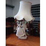 A ceramic table lamp depicting a lady and gentleman dancing, a small glass vase, a camera and a pair